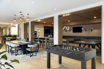 Game lounge with billiards, ping pong, foosball, and shuffleboard